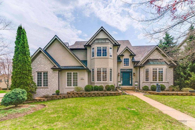 357 Torrey Pines Way, Vernon Hills, IL 60061 - view of front facade with stucco siding, stone siding, and a front lawn