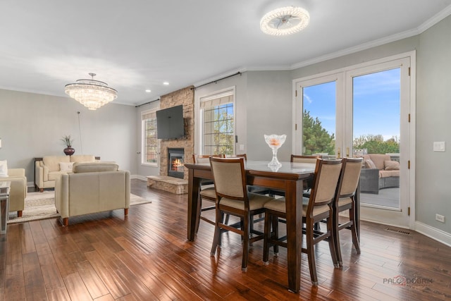 357 Torrey Pines Way, Vernon Hills, IL 60061 - dining space featuring a fireplace, dark wood-type flooring, crown molding, a chandelier, and baseboards