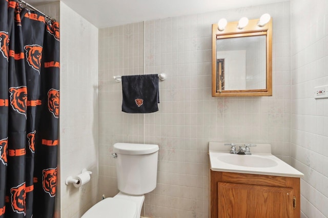 full bath featuring tile walls, vanity, a shower with shower curtain, and toilet