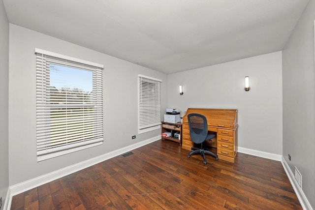 office area featuring visible vents, dark wood-style flooring, and baseboards