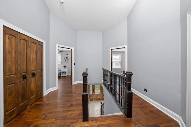 entryway with a high ceiling, hardwood / wood-style flooring, and baseboards