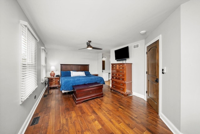 bedroom with visible vents, hardwood / wood-style flooring, and baseboards
