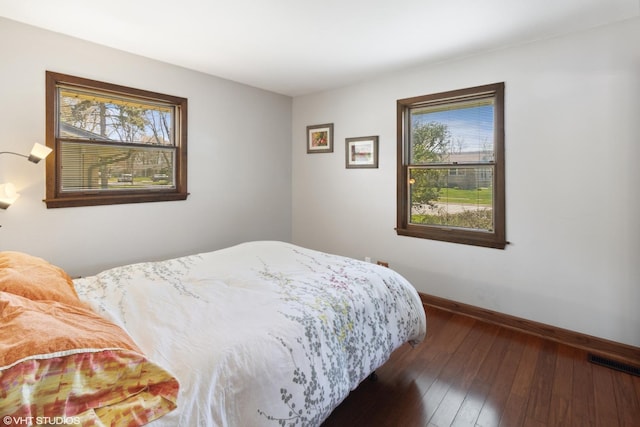 210 Walnut Ln, Elk Grove Village, IL 60007 - bedroom featuring baseboards, multiple windows, hardwood / wood-style flooring, and visible vents