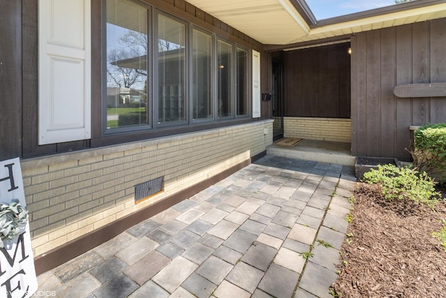 210 Walnut Ln, Elk Grove Village, IL 60007 - view of exterior entry featuring brick siding and visible vents