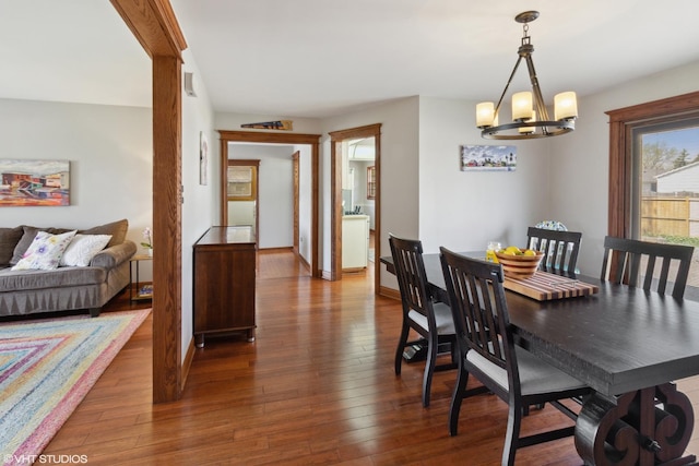210 Walnut Ln, Elk Grove Village, IL 60007 - dining room featuring baseboards, hardwood / wood-style floors, and a notable chandelier