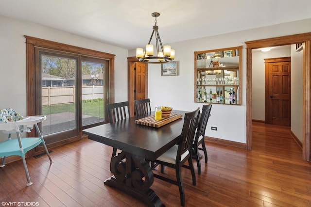 210 Walnut Ln, Elk Grove Village, IL 60007 - dining room featuring wood-type flooring, baseboards, and an inviting chandelier