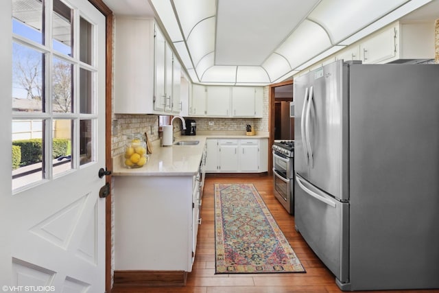 210 Walnut Ln, Elk Grove Village, IL 60007 - kitchen featuring decorative backsplash, wood finished floors, a sink, light countertops, and stainless steel appliances