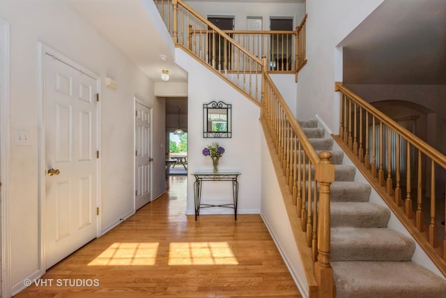 10600 Thornham Ln, Mokena, IL 60448 - stairs with wood finished floors, a high ceiling, and baseboards
