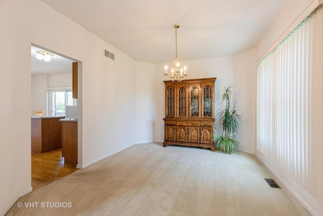 10600 Thornham Ln, Mokena, IL 60448 - unfurnished room with light colored carpet, a chandelier, and baseboards
