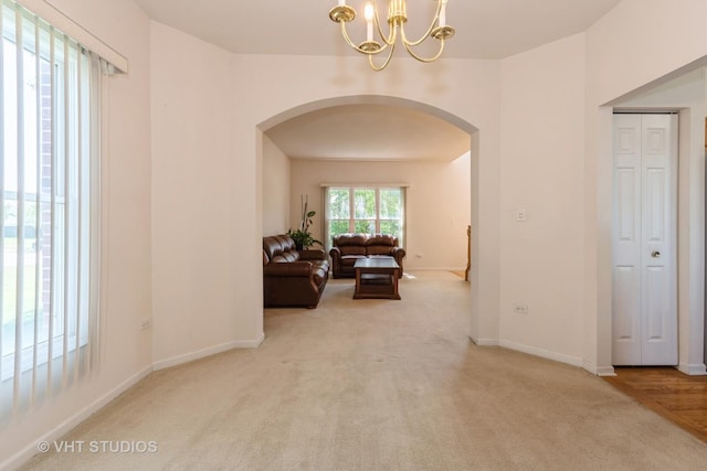 10600 Thornham Ln, Mokena, IL 60448 - corridor with arched walkways, a chandelier, carpet, and baseboards