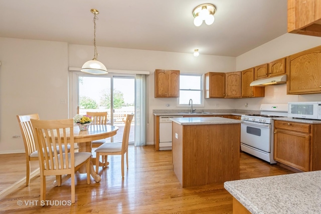 10600 Thornham Ln, Mokena, IL 60448 - kitchen with white appliances, under cabinet range hood, a kitchen island, light countertops, and decorative light fixtures