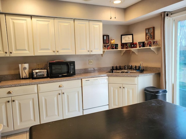kitchen featuring white cabinets, white dishwasher, black microwave, and a sink