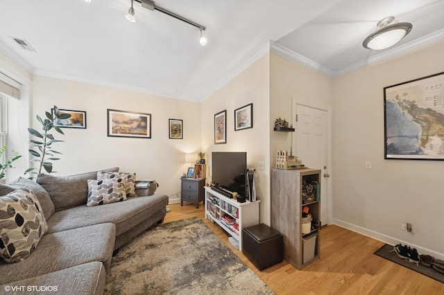 536.5 W Belmont Ave Unit 3N, Chicago, IL 60657 - living area featuring light wood finished floors, baseboards, visible vents, crown molding, and track lighting