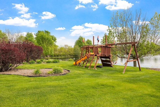 view of playground featuring a lawn and a water view