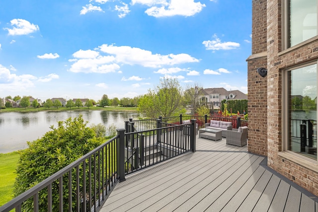 wooden terrace with an outdoor hangout area and a water view
