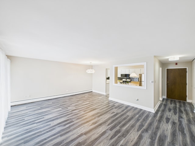 unfurnished living room with baseboard heating, baseboards, and dark wood-type flooring