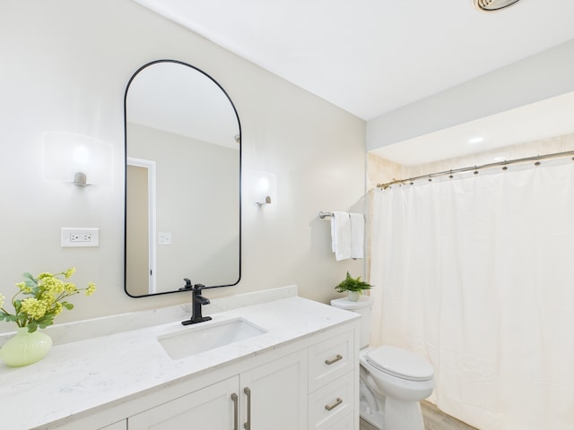 full bathroom with vanity and toilet