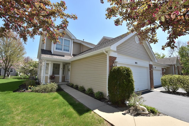2013 Waverly Cir, Saint Charles, IL 60174 - view of front of property featuring a garage, a front yard, a shingled roof, and asphalt driveway