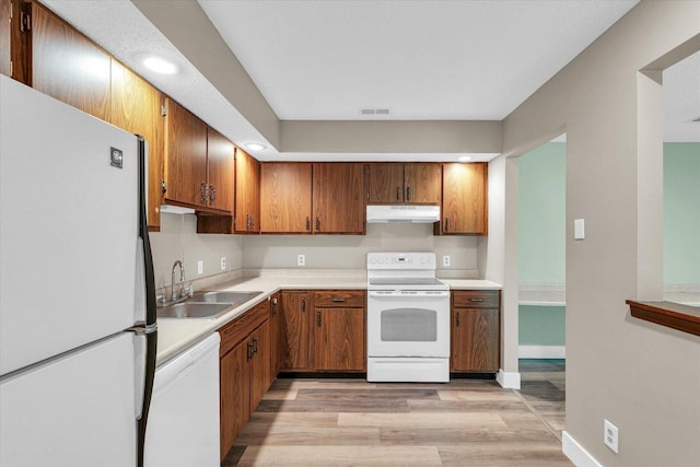 2567 Clayton Blvd Unit 2567, Champaign, IL 61822 - kitchen with white appliances, a sink, under cabinet range hood, light wood-type flooring, and light countertops