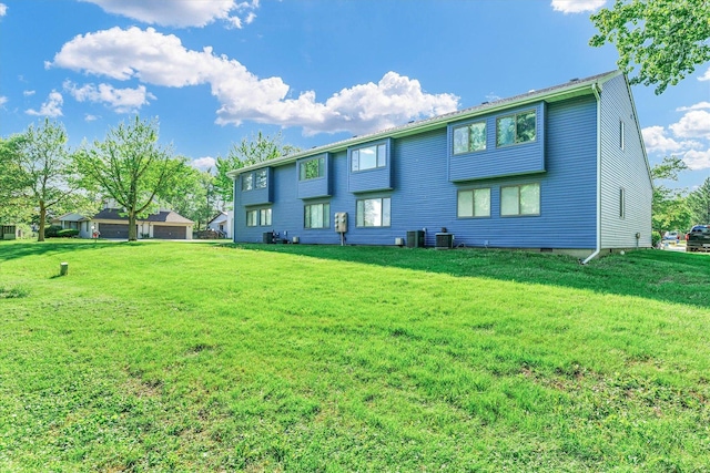 2567 Clayton Blvd Unit 2567, Champaign, IL 61822 - rear view of house with a yard, a garage, and central AC