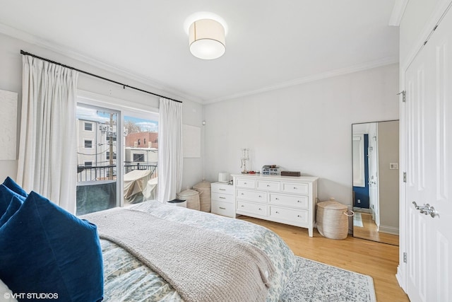 bedroom with ornamental molding, light wood finished floors, and access to exterior