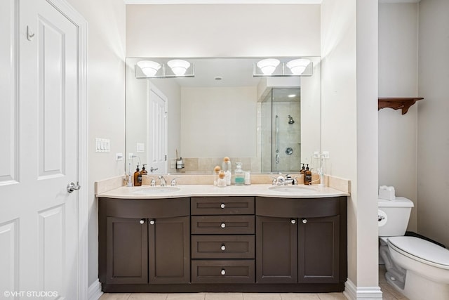 full bathroom with a shower stall, tile patterned flooring, toilet, and double vanity