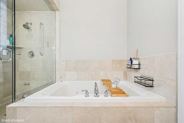 full bathroom featuring a shower stall and a tub with jets