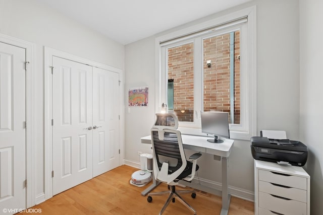 office area with light wood-type flooring and baseboards