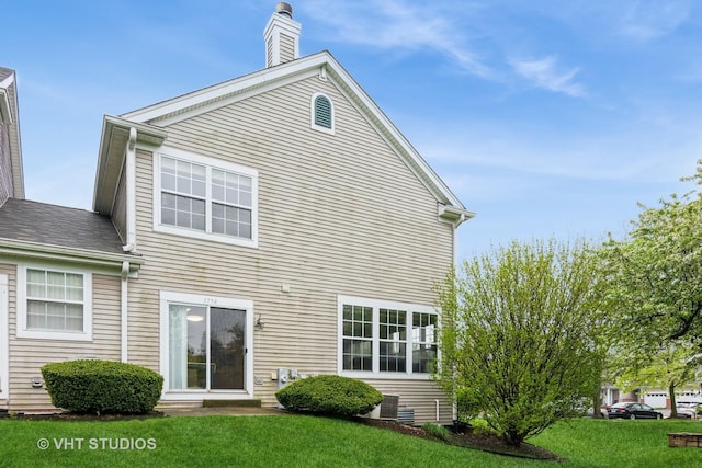 1754 Landreth Ct, Aurora, IL 60504 - rear view of property featuring a lawn and a chimney