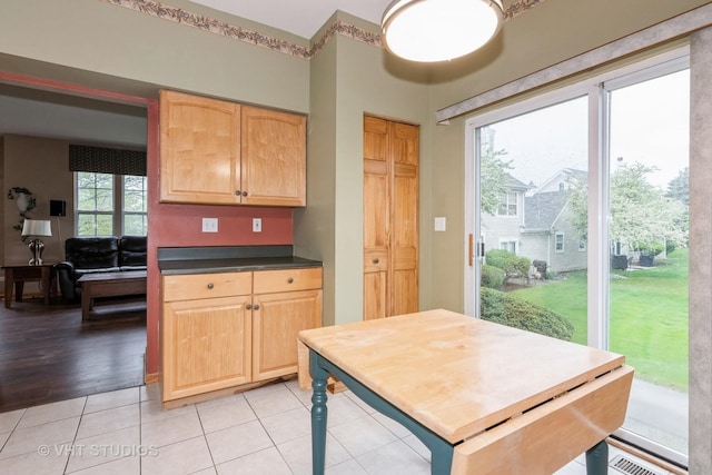1754 Landreth Ct, Aurora, IL 60504 - kitchen with light brown cabinetry, dark countertops, visible vents, and light tile patterned floors