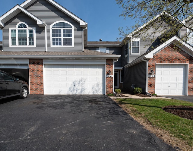 5464 Mayflower Jct, Rolling Meadows, IL 60008 - view of front of property with a garage, aphalt driveway, and brick siding