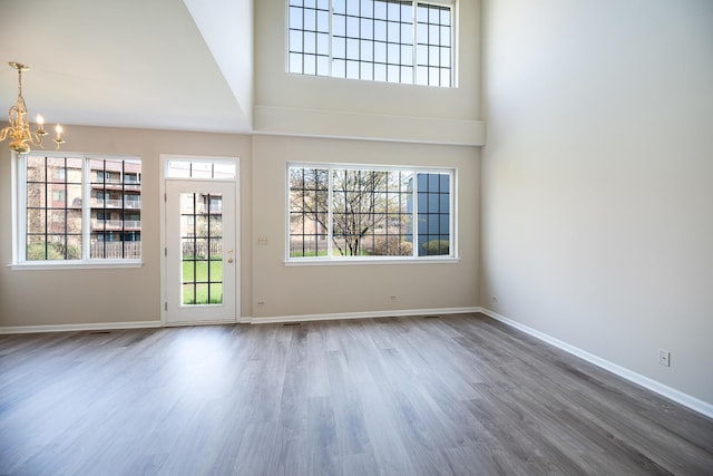 5464 Mayflower Jct, Rolling Meadows, IL 60008 - unfurnished living room featuring a chandelier, baseboards, wood finished floors, and plenty of natural light