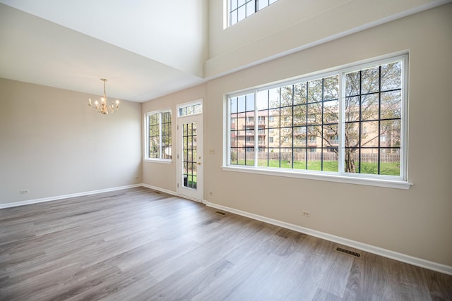 5464 Mayflower Jct, Rolling Meadows, IL 60008 - unfurnished room with wood finished floors, visible vents, a chandelier, and baseboards