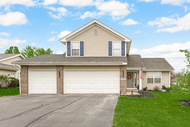 4240 Hearthstone Ln, Belvidere, IL 61008 - view of front facade featuring a front yard, brick siding, a shingled roof, and aphalt driveway