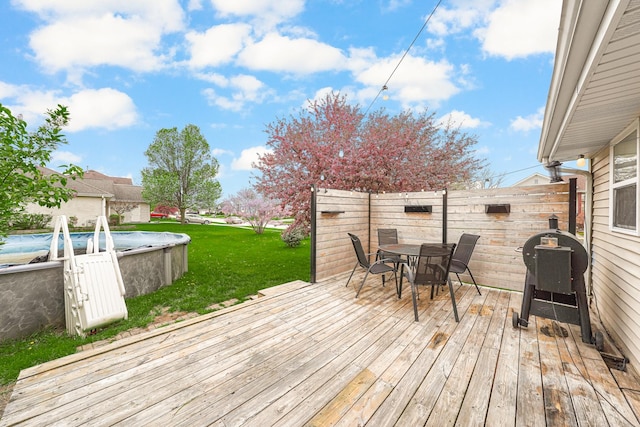 4240 Hearthstone Ln, Belvidere, IL 61008 - deck with a grill, fence, a lawn, outdoor dining area, and a fenced in pool