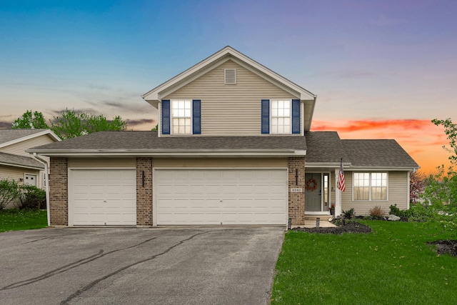 4240 Hearthstone Ln, Belvidere, IL 61008 - view of front of property with aphalt driveway, a shingled roof, brick siding, and a front yard
