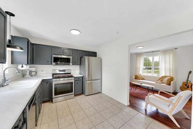 4240 Hearthstone Ln, Belvidere, IL 61008 - kitchen featuring light tile patterned floors, light countertops, stainless steel appliances, and a sink