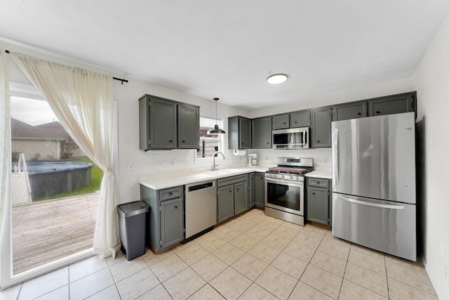 4240 Hearthstone Ln, Belvidere, IL 61008 - kitchen with light tile patterned floors, a sink, gray cabinets, light countertops, and appliances with stainless steel finishes