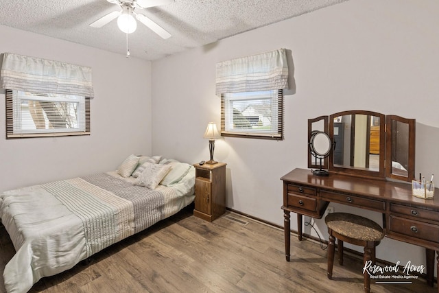 bedroom with wood finished floors and a textured ceiling