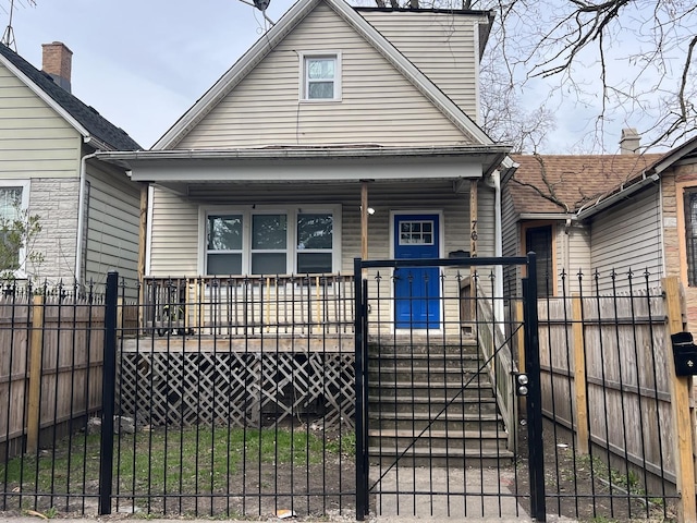 view of front facade featuring fence private yard and covered porch