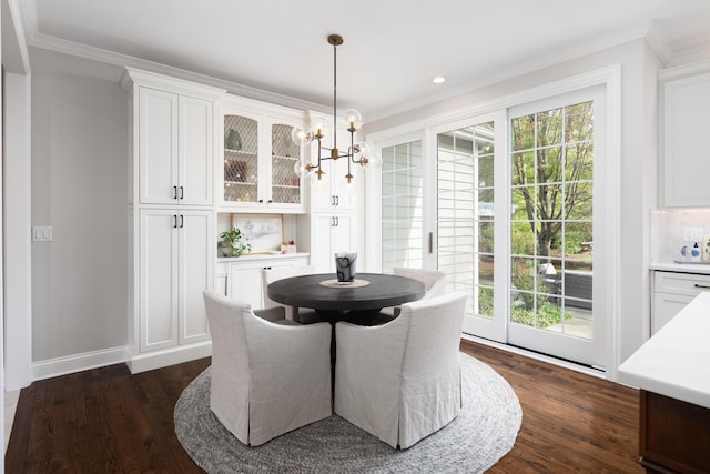 dining area featuring crown molding, baseboards, dark wood finished floors, and plenty of natural light