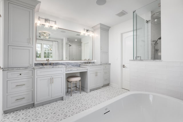 bathroom with a freestanding bath, vanity, tile patterned floors, a shower stall, and visible vents