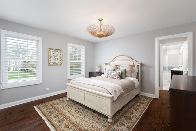 bedroom featuring baseboards and dark wood-style flooring