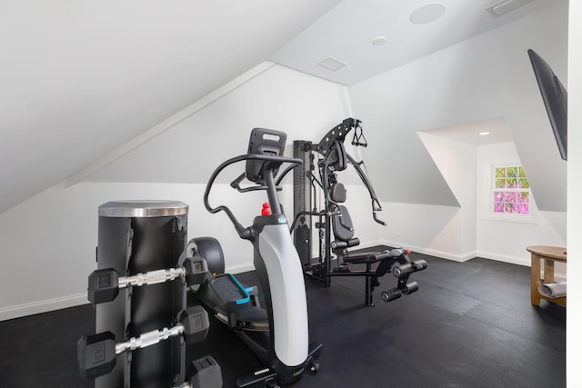 workout room with baseboards, visible vents, and lofted ceiling