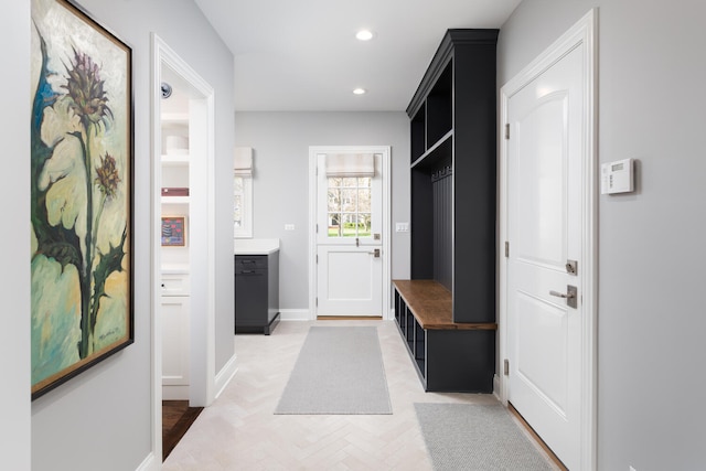 mudroom with recessed lighting and baseboards