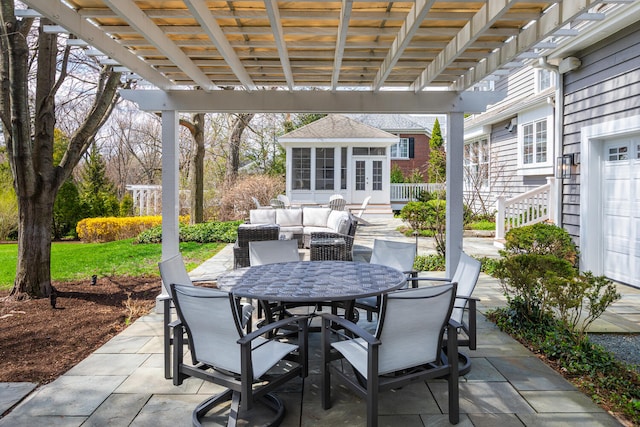 view of patio with an outdoor structure, a pergola, and outdoor dining space
