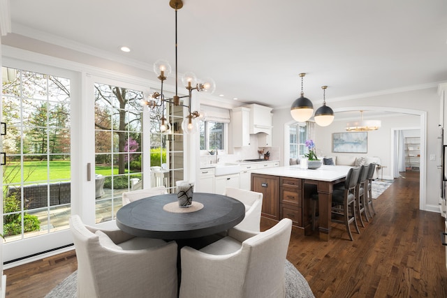 dining space featuring an inviting chandelier, recessed lighting, crown molding, and dark wood-style flooring