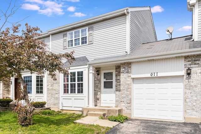 611 Cedar Ct, Romeoville, IL 60446 - view of front of house with a garage, a front lawn, aphalt driveway, and stone siding