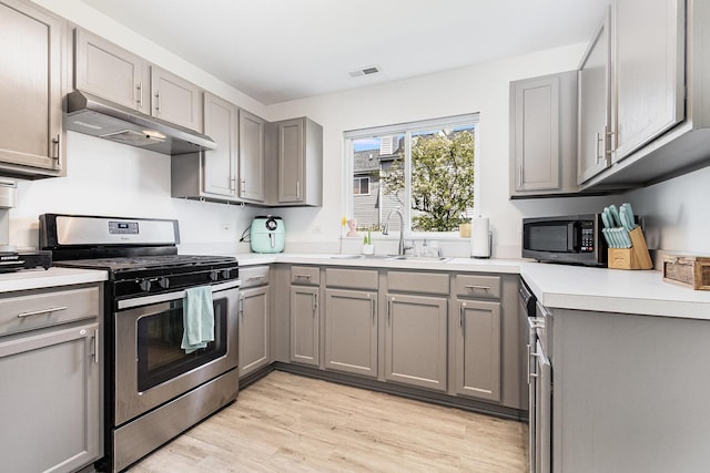 611 Cedar Ct, Romeoville, IL 60446 - kitchen with under cabinet range hood, gray cabinetry, appliances with stainless steel finishes, and a sink
