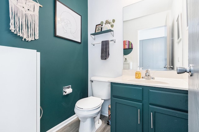 611 Cedar Ct, Romeoville, IL 60446 - half bathroom with toilet, baseboards, wood finished floors, and vanity